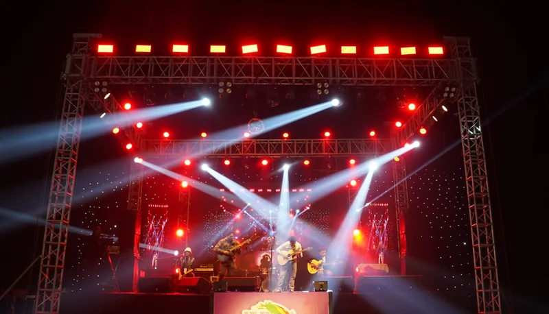 Truss-mounted stage lighting rig at a live corporate concert