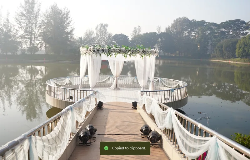 White draped gazebo and walkway decoration beside a lake